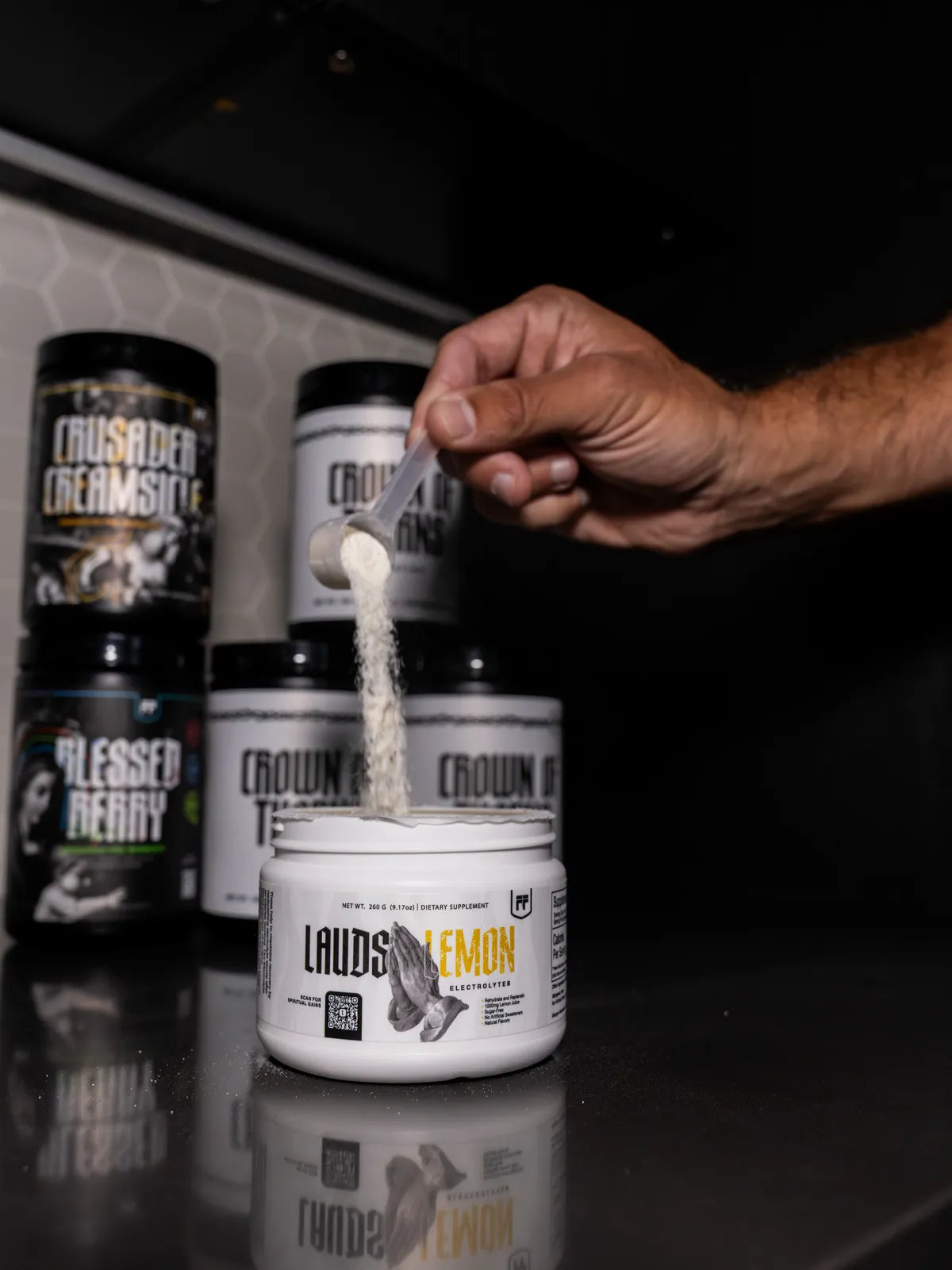 A scoop of Lauds Lemon electrolytes poured in front of the Flight Foods lineup
