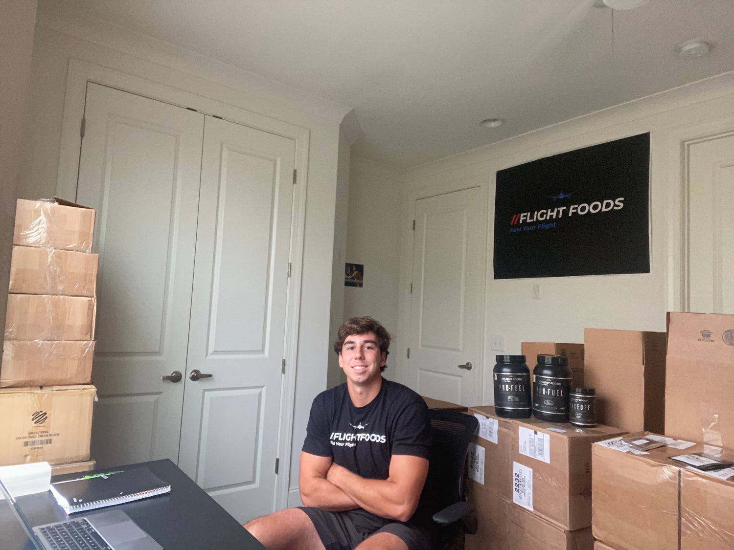 Thomas in his dorm room office with Flight Foods Supps