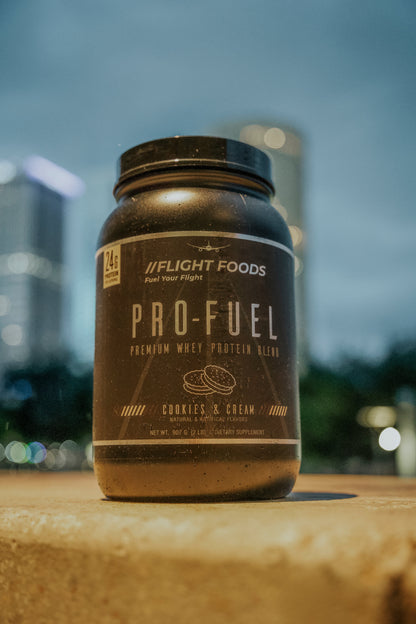 Container of Pro-Fuel Premium Whey Protein Powder displayed against a New York City skyline backdrop.