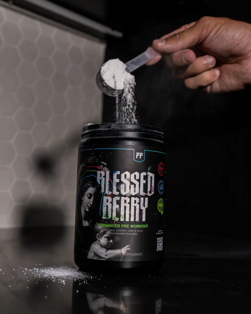 A scoop of Blessed Berry Enhanced Pre-Workout poured into the tub