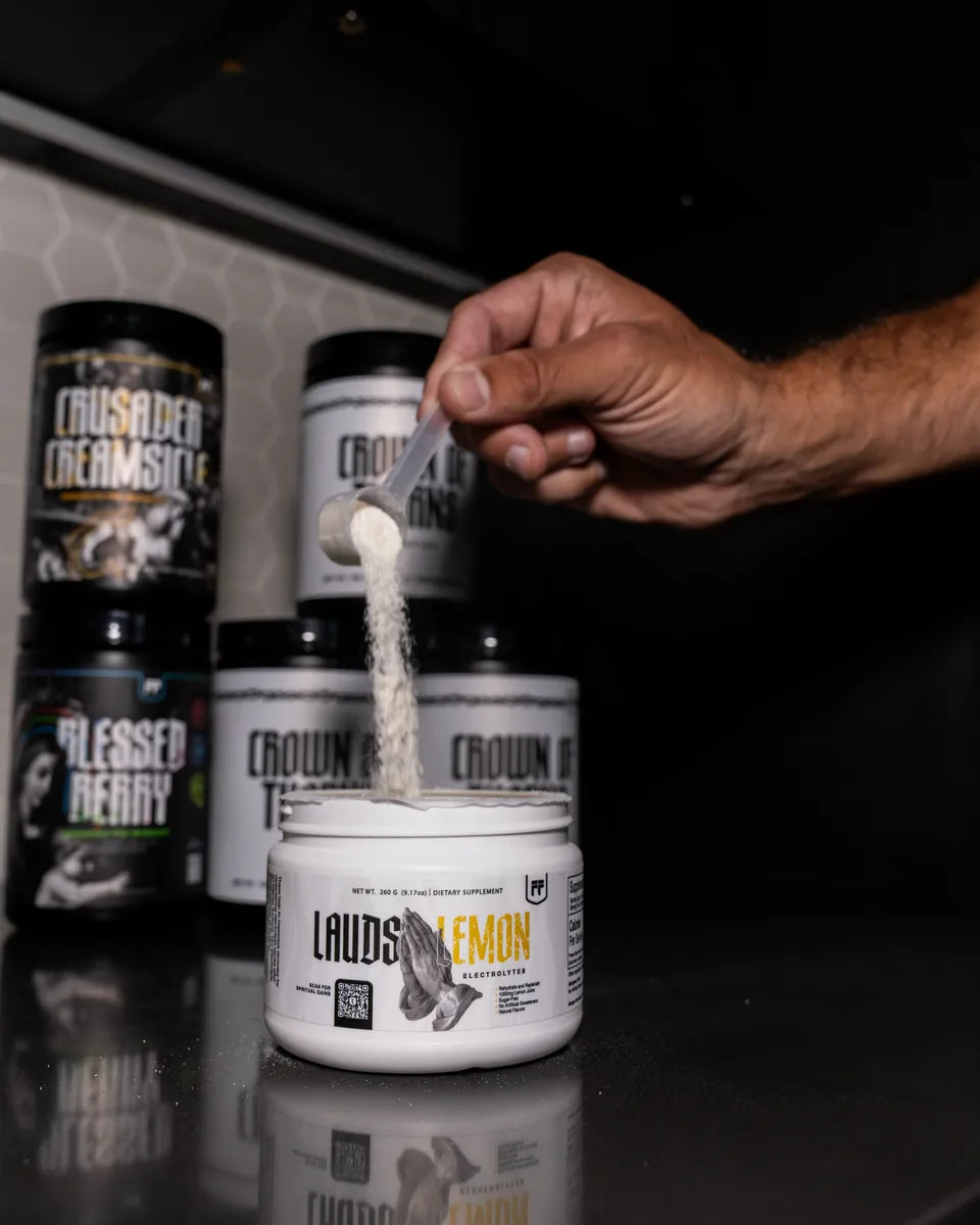 A scoop of Lauds Lemon Electrolytes poured into the tub