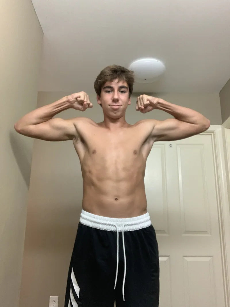 Thomas Lahart before his transformation, flexing in a hallway